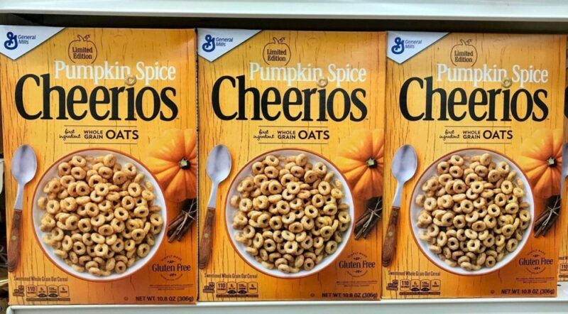 Three boxes of pumpkin spice cheerios on a shelf in a store