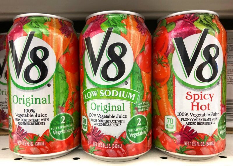 Three cans of V8 juice in different flavors