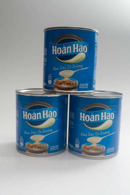 Three cans of condensed milk that are used in Vietnam for coffee and other drinks