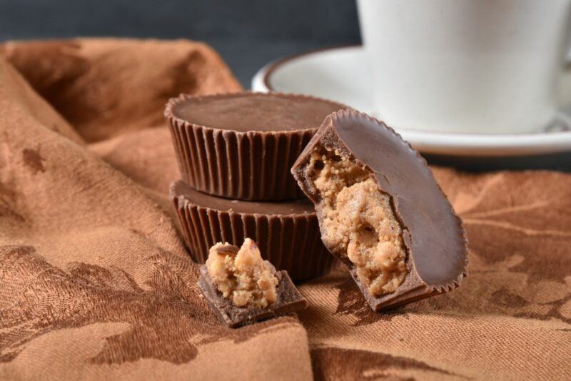 Two chocolate peanut butter cups stacked on each other, with another on its side