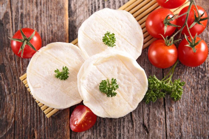 THree servings of goat cheese, tomatoes and peppers