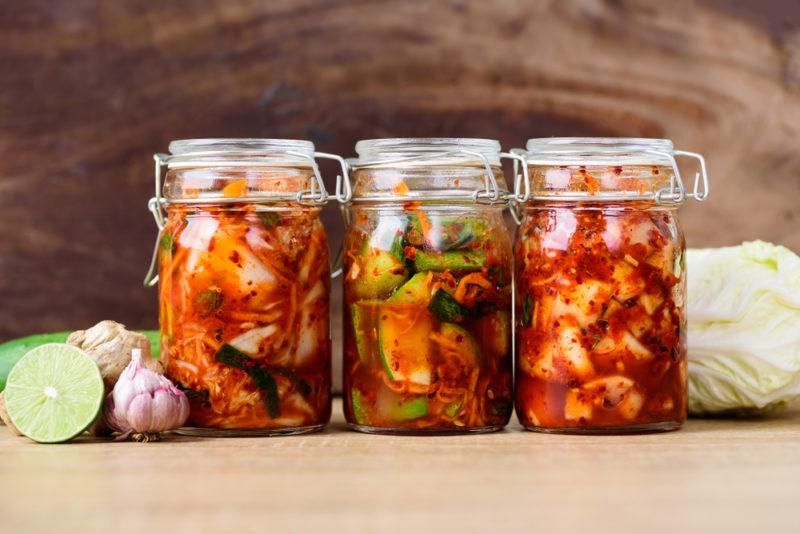 Jars of radish kimchi, cabbage and cucumber