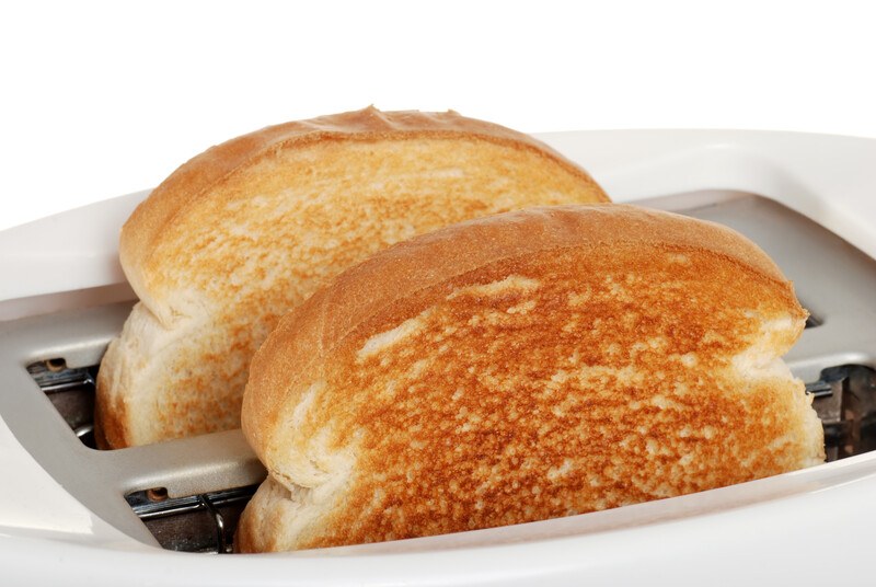 This photo shows two pieces of dry toast in a silver toaster.