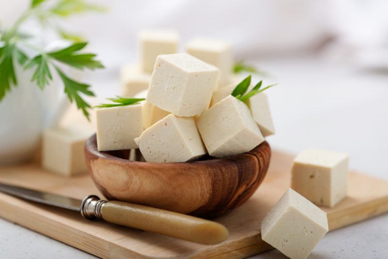 A wooden bown containing tofu cubes