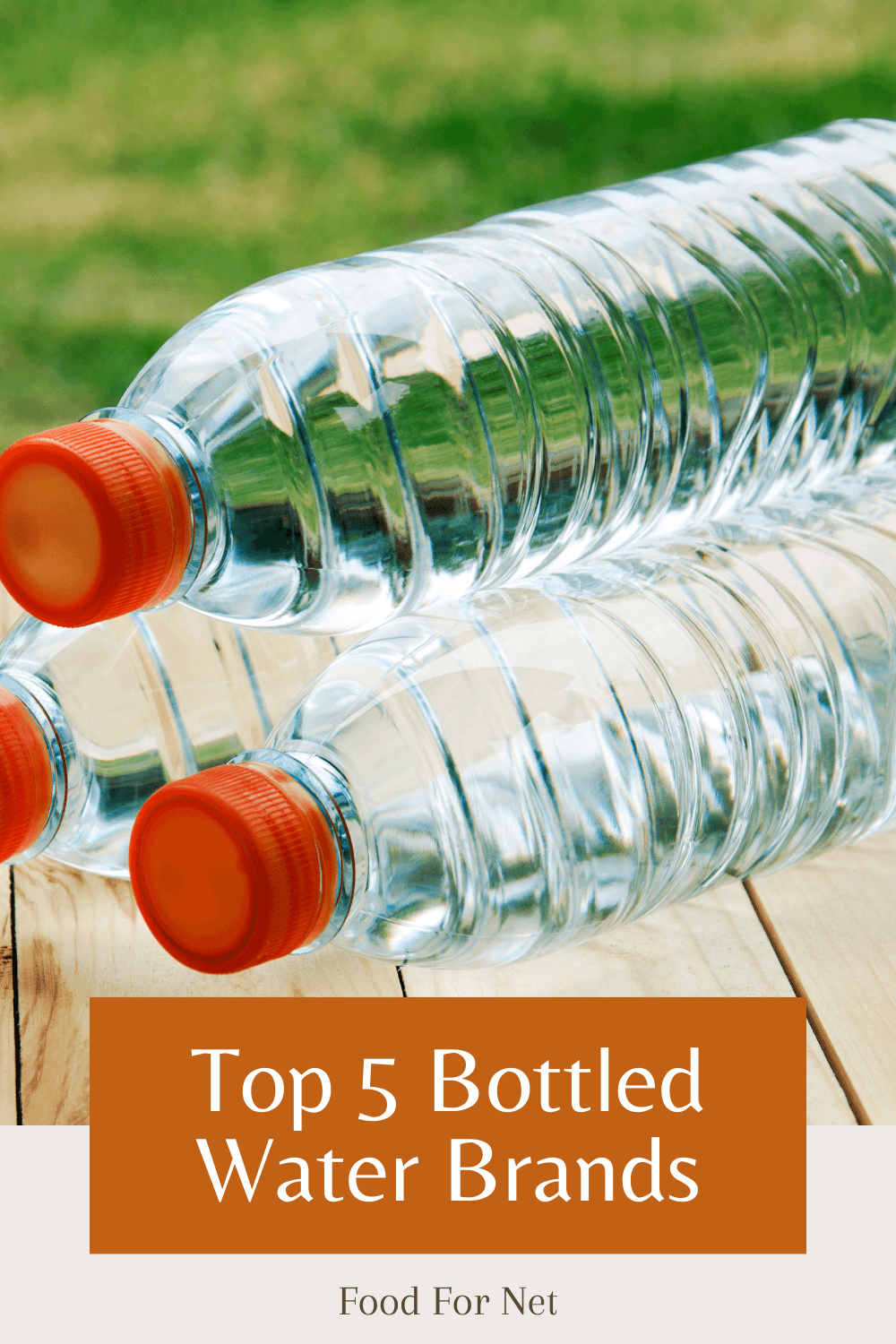 A few bottles of water with orange lids on a wooden table, representing the best bottled water brands