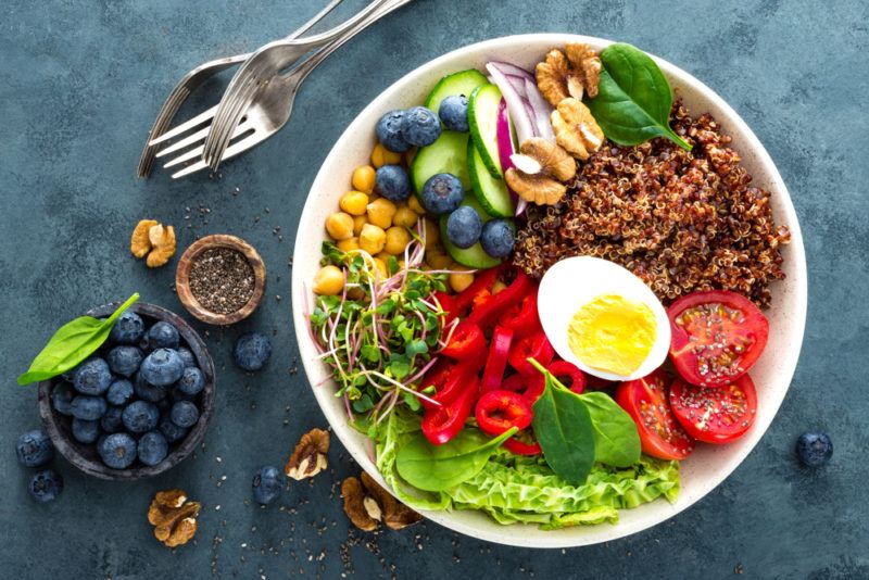 A white bowl with healthy ingredients and eggs