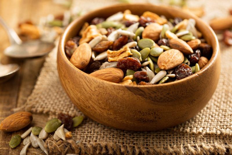 A wooden bowl with trail mix