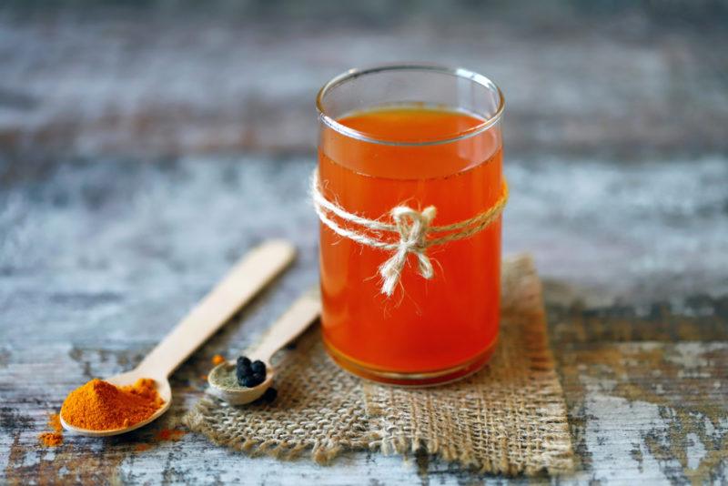 A glass containing turmeric and black pepper