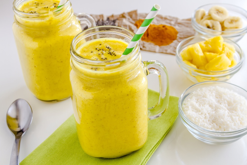 Two turmeric smoothies with various spices