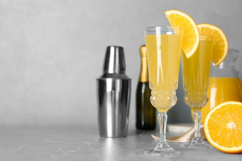 Two tall glasses containing Hawaiian mimosas