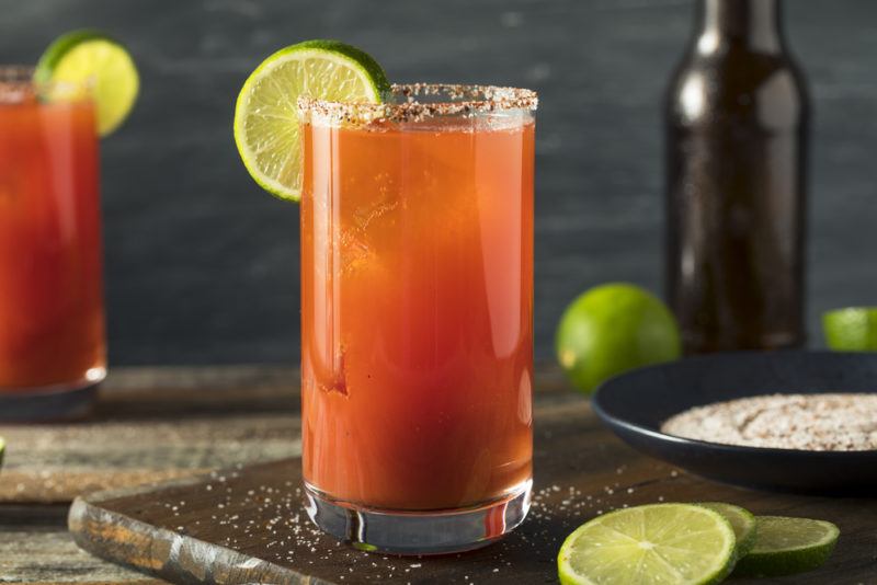 A Michelada cocktail on a slab in the foreground and another in the background