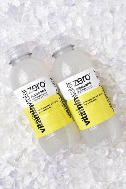 Two bottles of Vitaminwater lemonade against ice