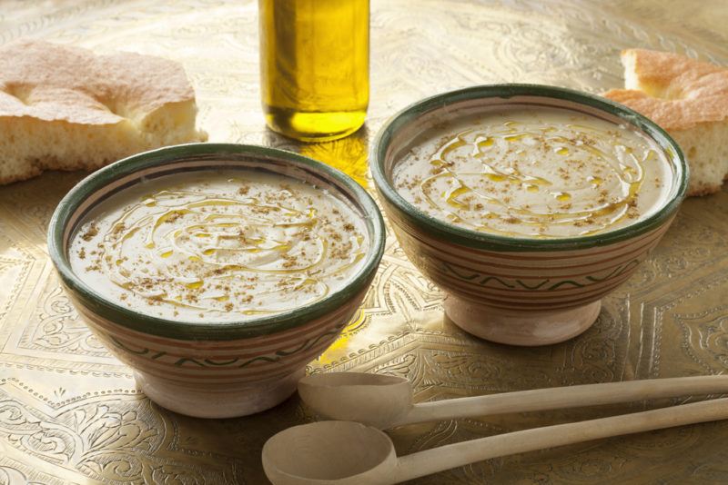 Two bowls that contain bessara on a table