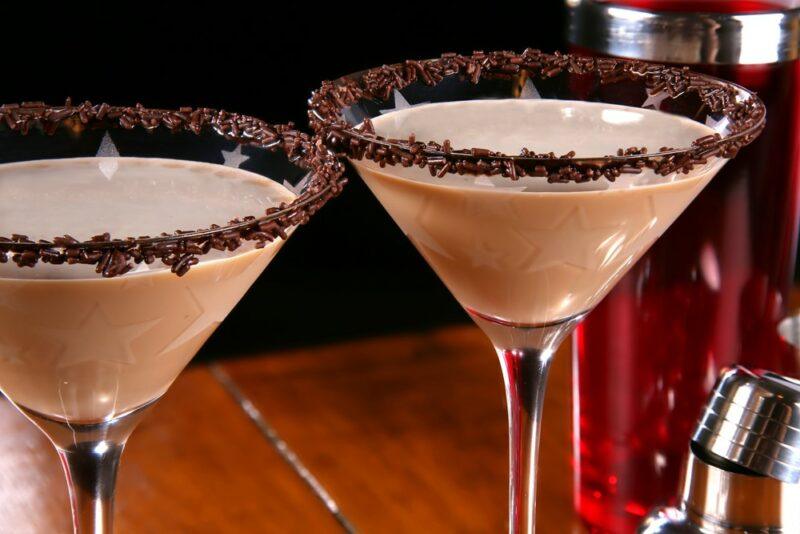 Two glasses of a chocolate vodka cocktail, with chocolate flake as a rim