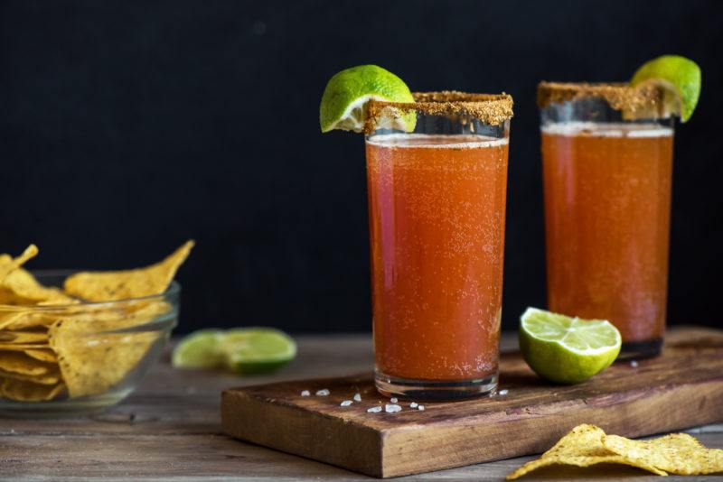 Two savory cocktails with chili salt along the rim