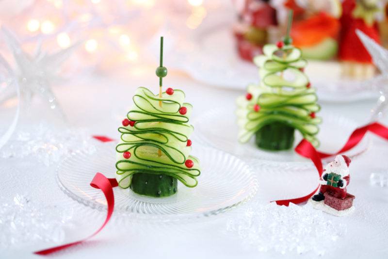 Two Christmas trees made out of sliced cucumber