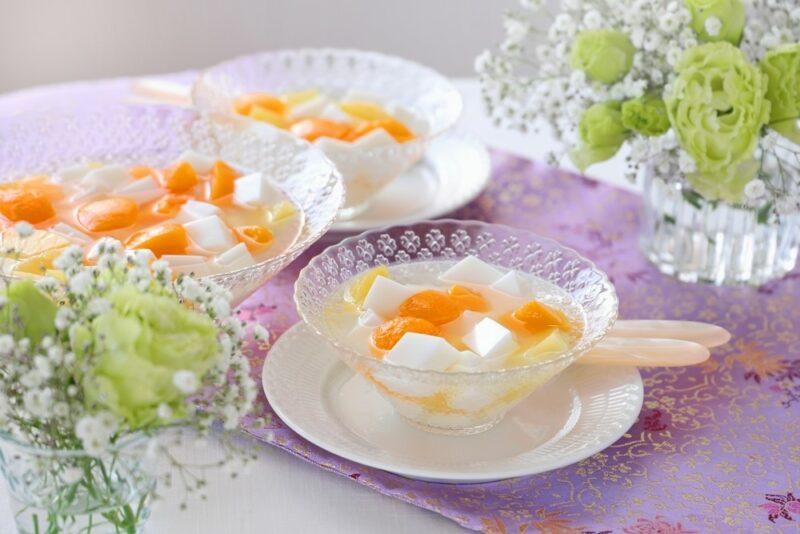 Three different dishes that each contain almond jelly, fruit salad, and syrup