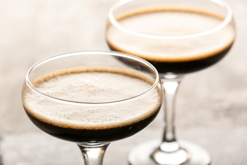 Two coupe glasses containing a Guinness margarita