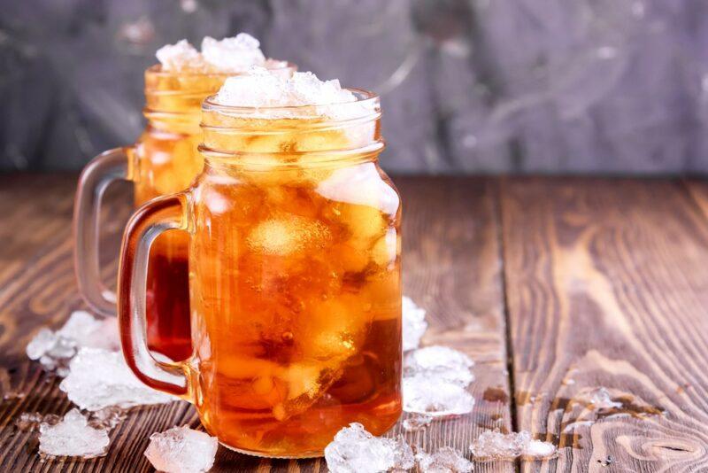 Two mason jars containing a root beer rickey cocktail