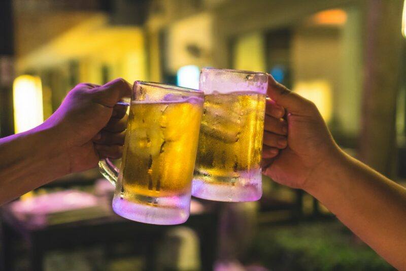 Two people chinking together beer glasses, which contain a Yorsh cocktail