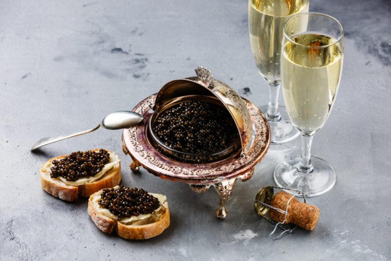 Two glasses of champagne next to caviar