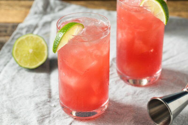 Two glasses containing a red tropical bay breeze cocktail