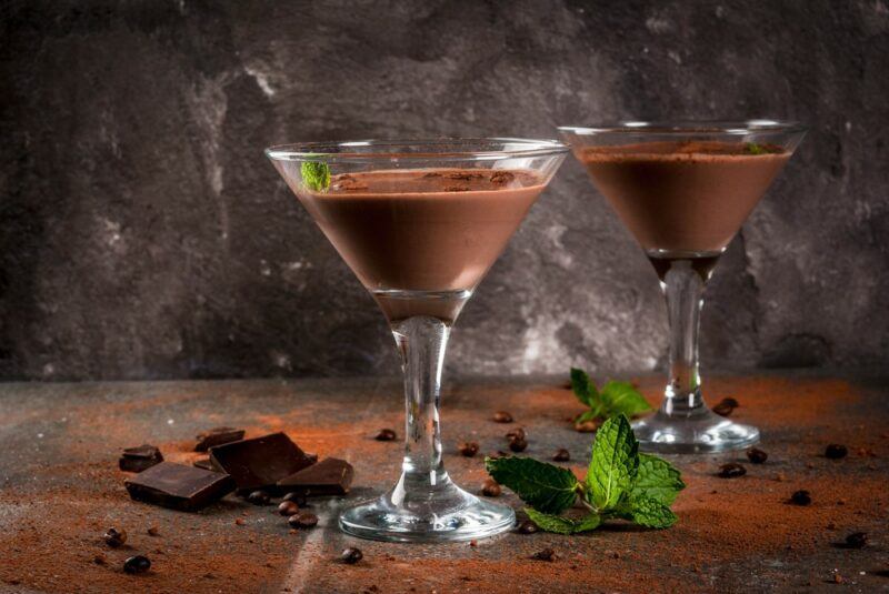 Two martini glasses containing a chocolate liqueur based cocktail