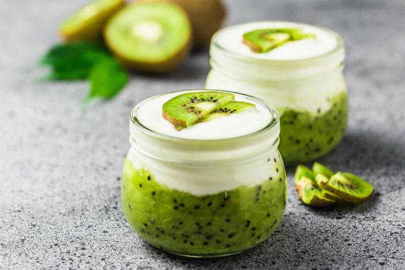 Two jars of a dessert made using kiwis and yogurt