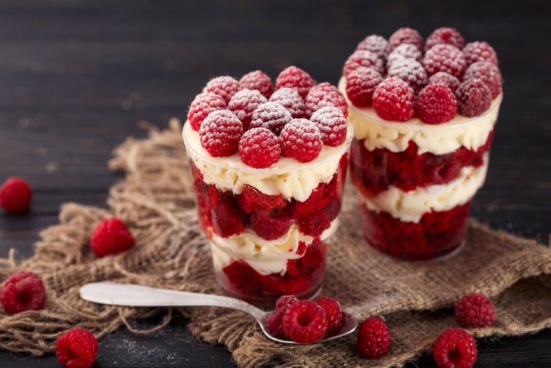 Two layered parfait desserts made with raspberries