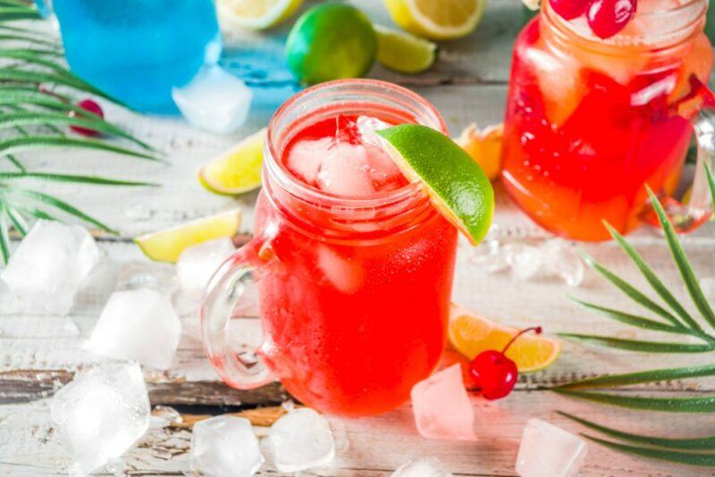 Two mason jars containing a bright Hawaiian sea breeze cocktail