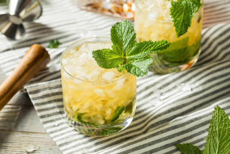 Two mint julep cocktails on a cloth