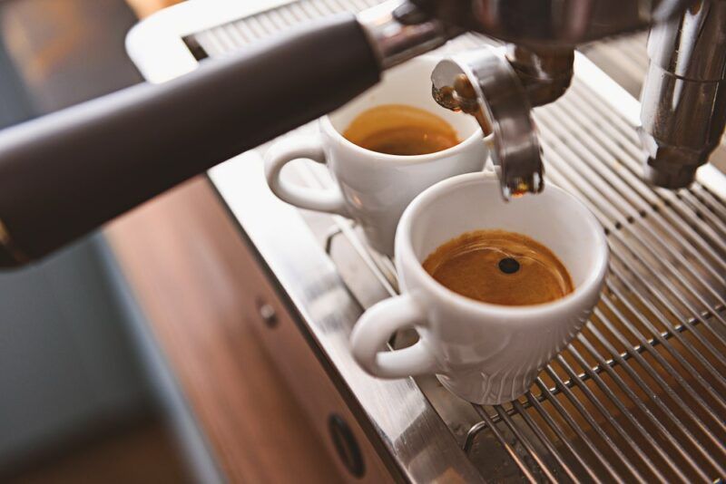 Two espresso coffees being made at home or in a restaurant