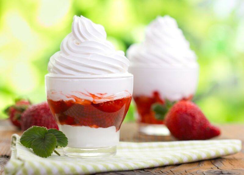 Two glasses containing a frozen yogurt parfait