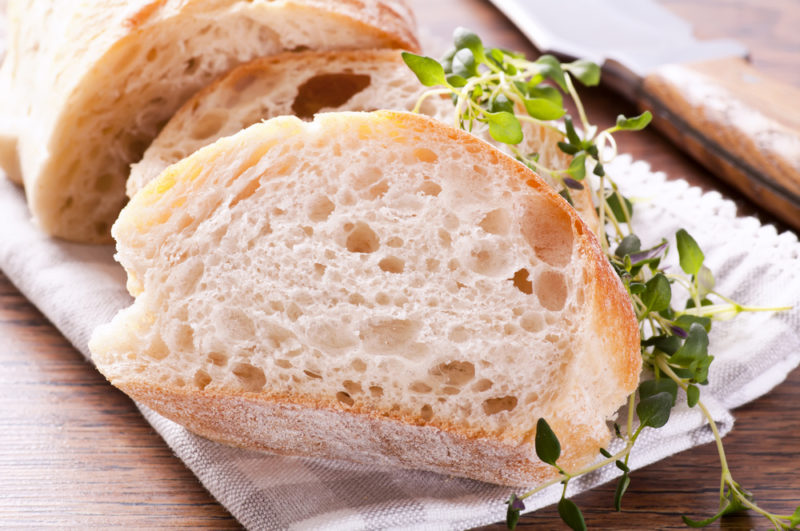 Two pieces of fresh bread on parchment paper