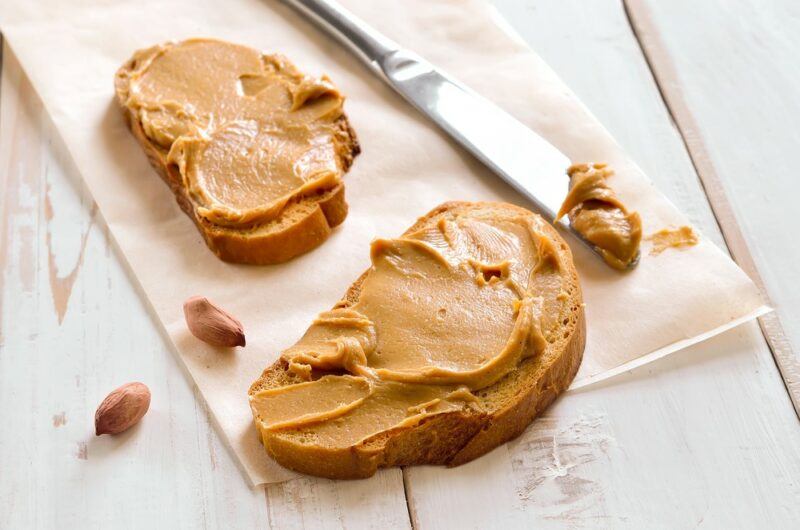 Two pieces of peanut butter toast with a knife