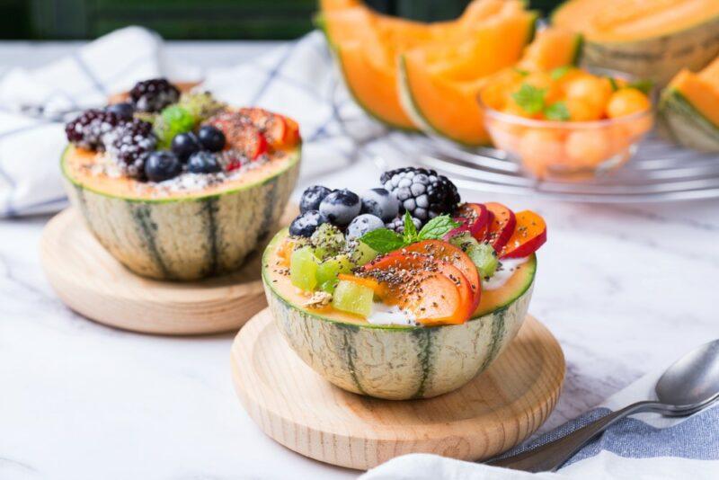 Two fruit salads that have been made using cantaloupe halves