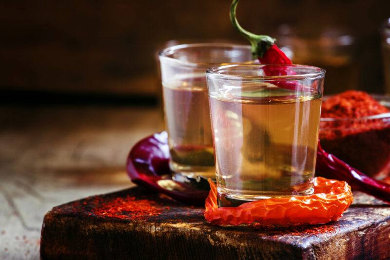 Two small glasses of vodka with peppers, highlighting the idea of the best Ukrainian vodka