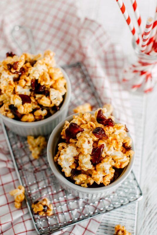 Two light blue bowls containing maple bacon popcorn