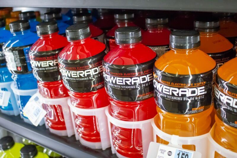 A selection of Powerade bottles on a grocery store shelf