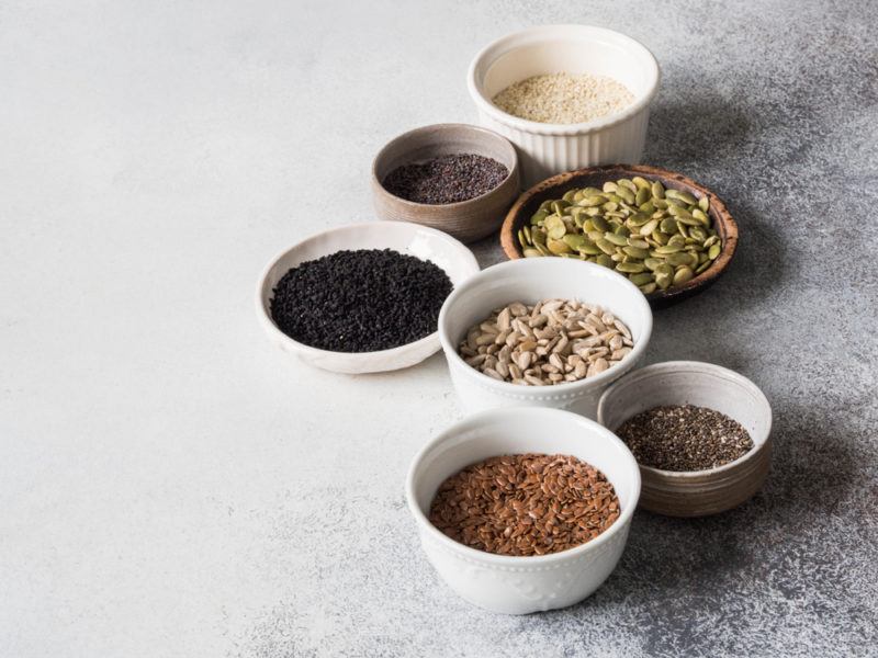 Small bowls filled with different types of seeds