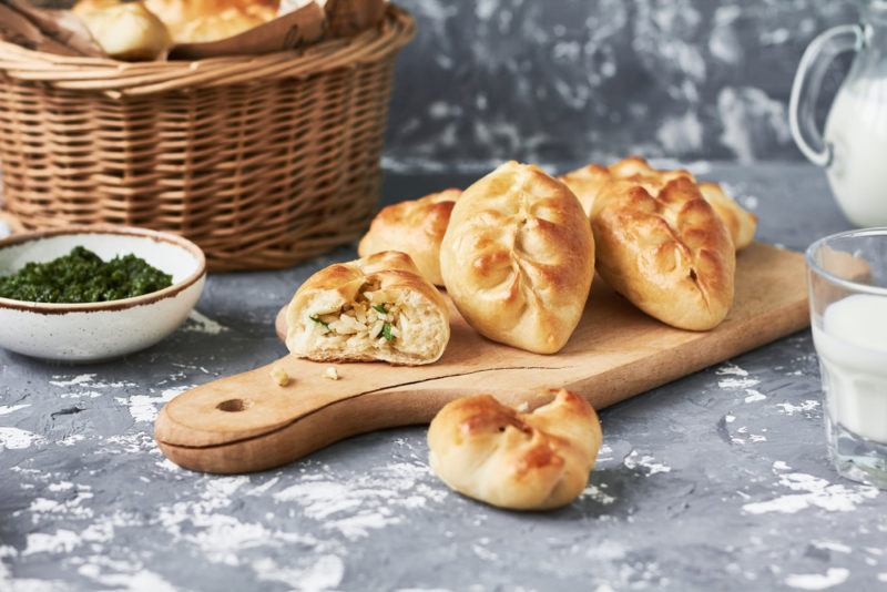 Various pirozhki on a wooden board