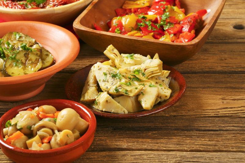 Small plates of pickled vegetables on a wooden table