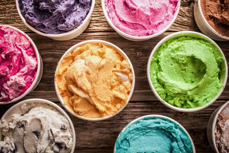 Small pottles of ice cream in various colors, including green, pink, purple and orange