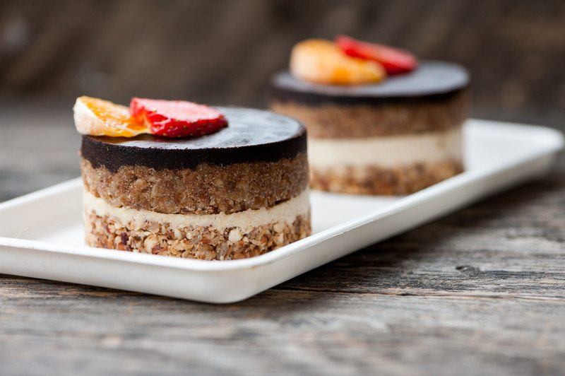 Vegan Cheesecake Recipes | Food For Net vegan cheesecake with chocolate topping, granola, and sliced fruit on top