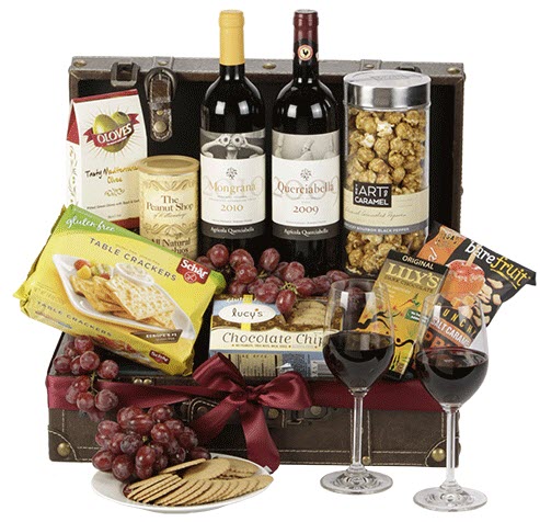 A suitcase that contains wine, crackers and cookies. 