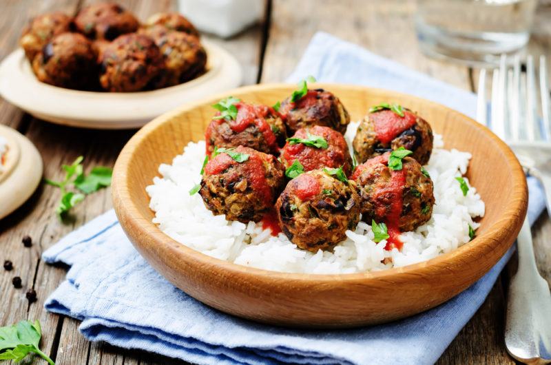 Two bowls with vegan meatballs and rice