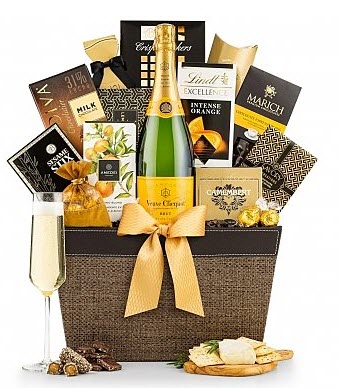 Veuve Clicquot Tasting Gift Basket | Food For Net A brown wine basket with a bottle of wine, chocolates and other snacks.
