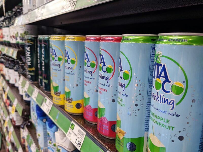 A grocery store shelf with a selection of sparkling Vita Coco coconut water