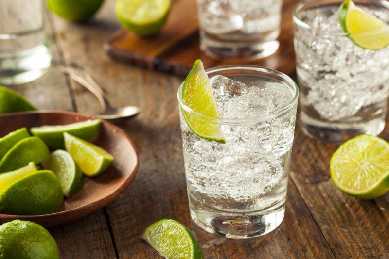 Multiple glasses of vodka soda with slices of lime