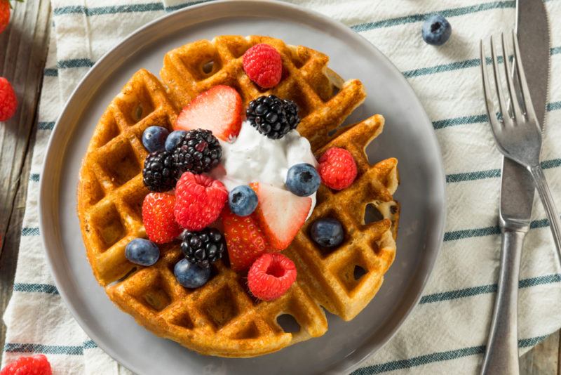 Fresh waffles on a plate with fruit